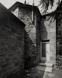 View from SE showing 18th century polygonal stair turret with blocked window at ground floor level.