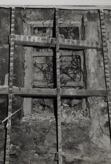 Interior.
Detail of blocked window in ground floor SE room showing astragals.