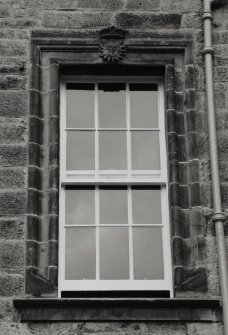Detail of window with heraldic keystone.