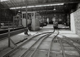 Newtongrange, Lady Victoria Colliery, Pithead Building (Tub Circuit, Tippler Section, Picking Tables)
Pithead upper decking level, Tub Circuit: view from east on north side of tub circuit, showing track dividing as it approaches shaft (behind), and tippler control cabin (left)