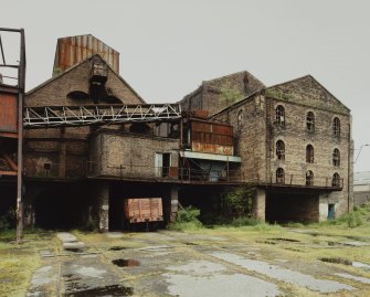 View from SW of S gables of brick-built Hopper (Left) and Old Washer (right), prior to restoration.  The view also shows the railway lines emerging from the lower level of the pit-head complex.