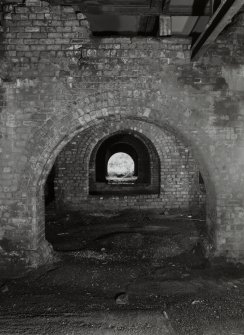 Newtongrange, Lady Victoria Colliery, Pithead Building (Tub Circuit, Tippler Section, Picking Tables)
Detailed interior view from E looking through the arcades of brick arches separating the railway sidings passing under the colliery's surface buildings.  Wagons were filled from conveyors and hoppers in the floors above, which contained the Picking Tables