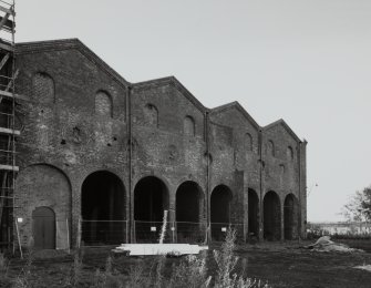 Newtongrange, Lady Victoria Colliery, Pithead Building (tub Circuit, Tippler Section, Picking Tables)
View from NE of W end of N facade of colliery, showing arches into which railway wagons entered to be filled from the hoppers and conveyors in the buildings above