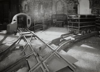 Newtongrange, Lady Victoria Colliery, Pithead Building (Tub Circuit, Tippler Section, Picking Tables)
Pithead upper decking level, Tub Circuit: view from north east showing east end of tub circuit, with cage and shaft just visible (right), and elevating creeper (distant left)