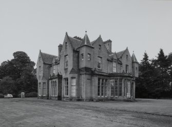 View from NW showing bowed conservatory at centre