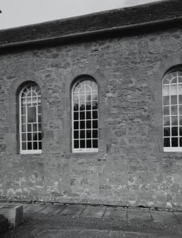 Detail of arched windows and stonework including blocked doorway