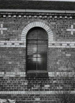 Detail of arched window and polychrome brickwork.