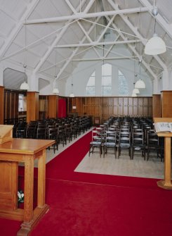 Interior. 
View from SSE showing the nave chairs and N window.