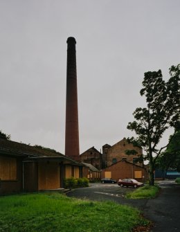 General view from NNW of N end of works, including boilerhouse chimney, and main office (foreground left)