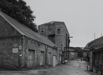 View from NNW of electricians' workshop (foreground left), 'clay building' (centre left) and ball mill (distant left), with part of main paper mill visible to right