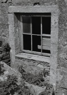 Detail of window at basement level to right of main entrance.