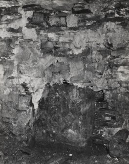 Interior.
Detail of slab built into the base of the N wall of the W apartment of the dwelling-house.