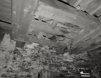 Scar Steading: Detail of underside of first floor in the grain mill showing the millstones supporting timbers