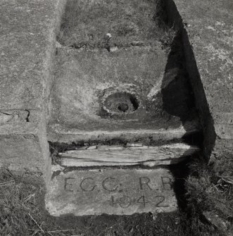 Detail of oil barrel drain and inscription