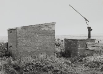 View of pump house and hand pump from NW