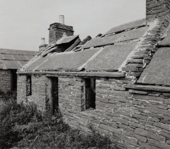 S-E range.  View of house at N end from S showing one piece wall-head stone