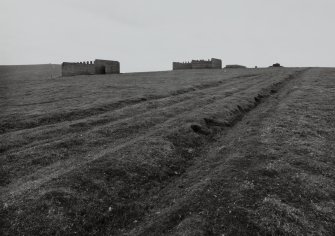 View of brick buildings and access road from ENE.