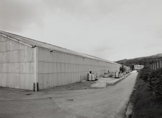 View from SW of SE side of works, with two wooden fresh water tanks in distance