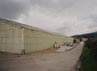 View from SW of SE side of works, with two wooden fresh water tanks in distance