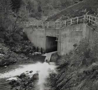 Dam (NM 97 42) supplying water to works: view of spillway emerging from base of dam