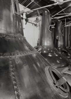 Still House:  view from SE of riveted wash still (foreground), with two spirit stills (welded copper) in background, and wash charger in far distance (low wines charger out of picture to right)