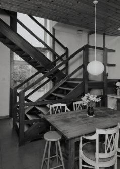 View of Kitchen from East showing open tread staircase.
