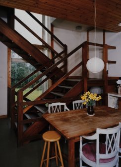 View of Kitchen from East showing open tread staircase.