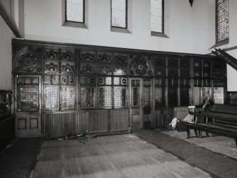 Nave, detail of stained glass wall along length of entrance porch, view from North East