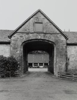 View of arched entrance to courtyard from W