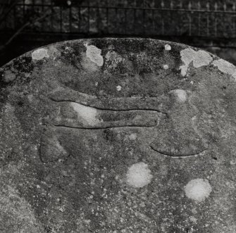 Detail of carved axes on back of headstone of John McArthur (1769).