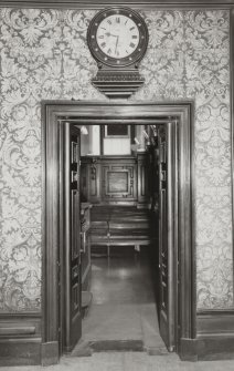 Interior.
View of SW doorway of NW boardroom with clock above.