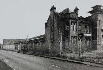 View from North-West of offices on corner and single storey brick built range.