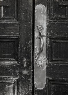 Interior.  Detail of handle and finger plate on Main hall entrance door.