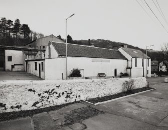 General view from SW of main production (NE) block of distillery, containing Still House, Mash House, Tun and Mill Rooms, and Boiler House, with former Manager's House