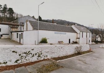 General view from SW of main production (NE) block of distillery, containing Still House, Mash House, Tun and Mill Rooms, and Boiler House, with former Manager's House