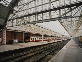 View of platforms from WSW, showing Strathclyde Passenger Transport Executive electric train (in new maroon and cream livery)