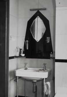 Interior.
Detail of mirror and hand wash basin in North-West bathroom.