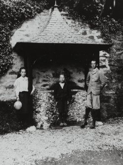 Photographic copy of view of 3 children standing near decorative shelter in garden.
PHOTOGRAPH ALBUM NO: 21  : CYCLE TOUR ALBUM