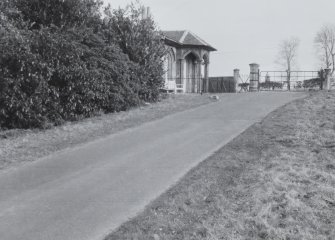 View from drive showing lodge porch and gates.