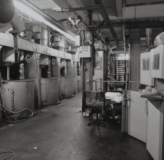 Interior view of the Affination Centrifugal Machines, showing the motor drives and the Magma Supply Hopper.  The machines separated the impurities coating the sugar crystal from the crystal (T&L No.: 21178/7)