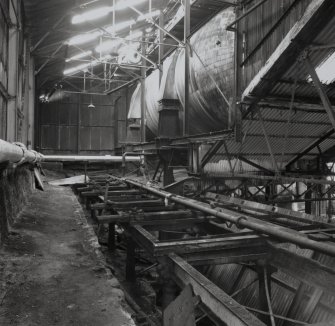 Interior view of the refinery Steam Accumulator, used for storing steam for the process.  Visible in the foreground is the old railway siding used in the past for supplying coal to the Boiler House (T&L No.: 21178/3)