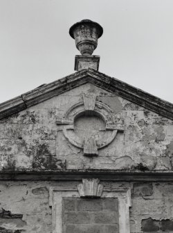 East pediment surmounted by decorative urn, detail
