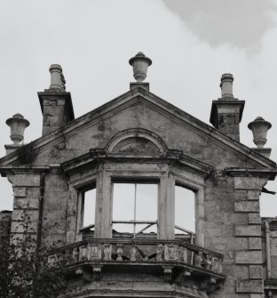 South bay window surmounted by pediment and decorative urns, detail