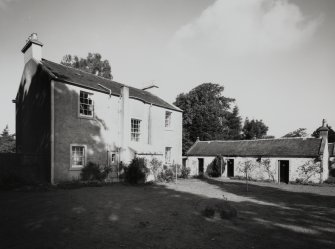 General view of house and outbuildings from SW.