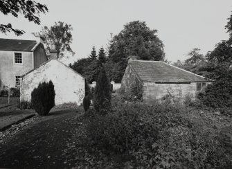 General view of house and outbuildings from SE.