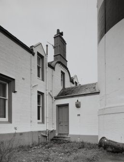 View of cottage rear, wallhead chimney stack and base of lighthouse from NNW