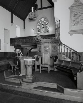 Interior. Platform area showing pulpit, font and communion table