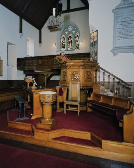 Interior. Platform area showing pulpit, font and communion table