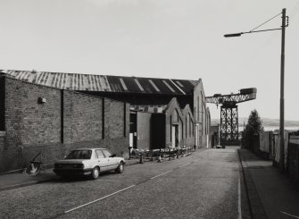 General view from SW along SE side of works (Ratho Street), 			with giant-cantilever crane beside James Watt Dock (NS27NE 17) in 		background, photographed 10 August 1993
