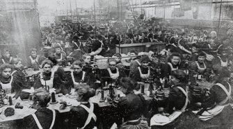 Copy of historic photograph showing interior view of knitting department.